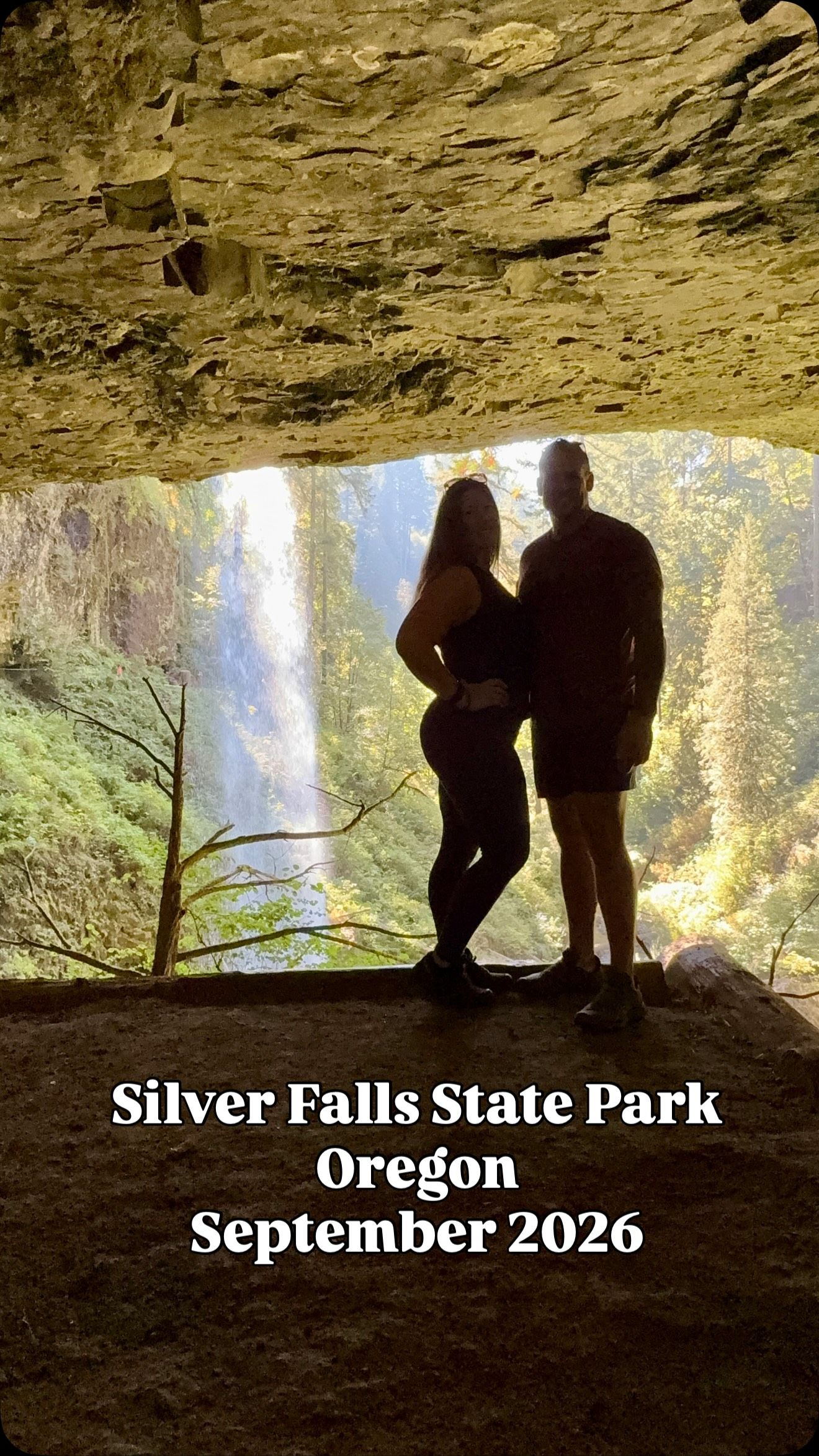 Danny and Laura silhouetted behind a waterfall at Silver Falls State Park