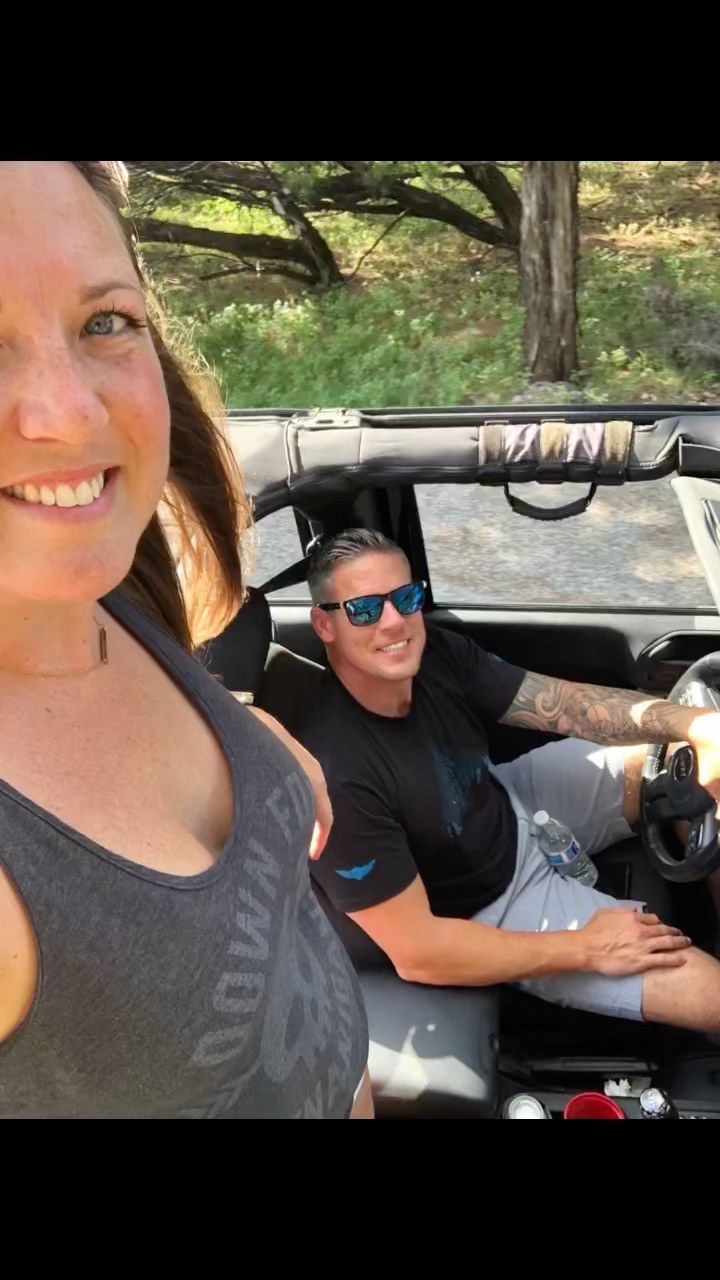 Danny and Laura cruising in an open-top Jeep