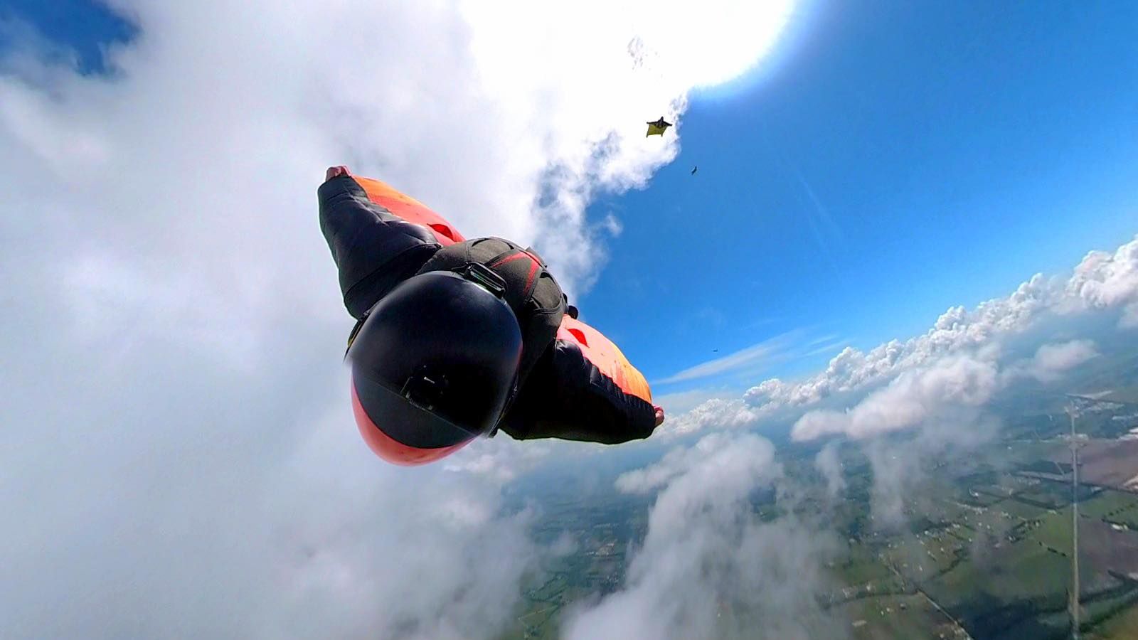 Danny flying a wingsuit high above the clouds