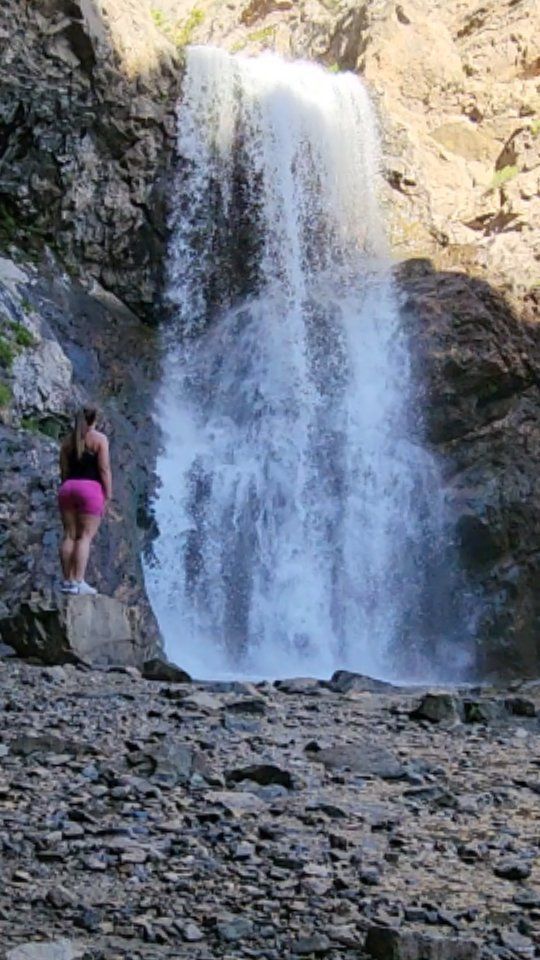 Laura in front of a roaring waterfall